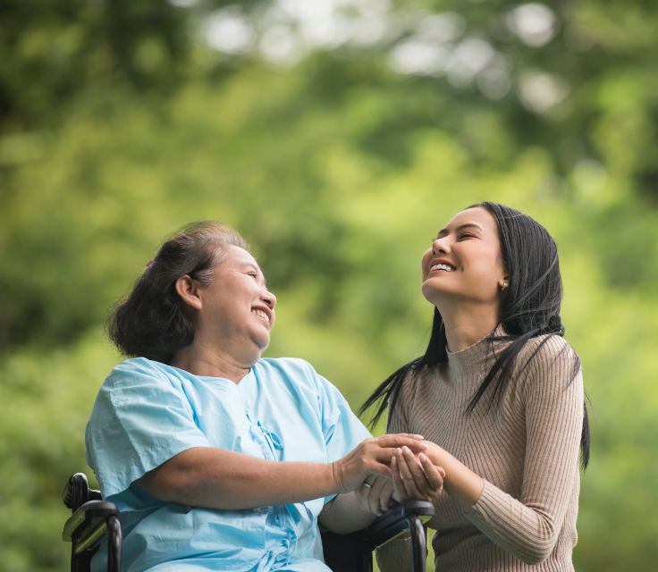 A support worker and a resident sharing a moment outside supported accommodation